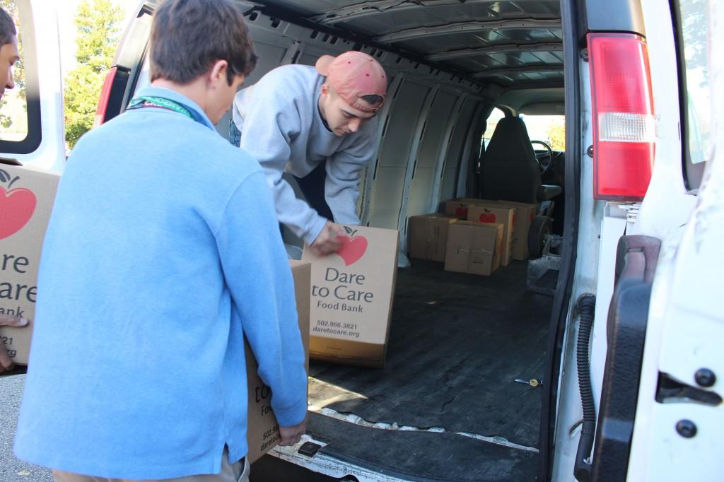 Trinity students help load food items into the Dare to Care truck. In addition to the food, Trinity donated more than $7,000. photo by Tyler Harris