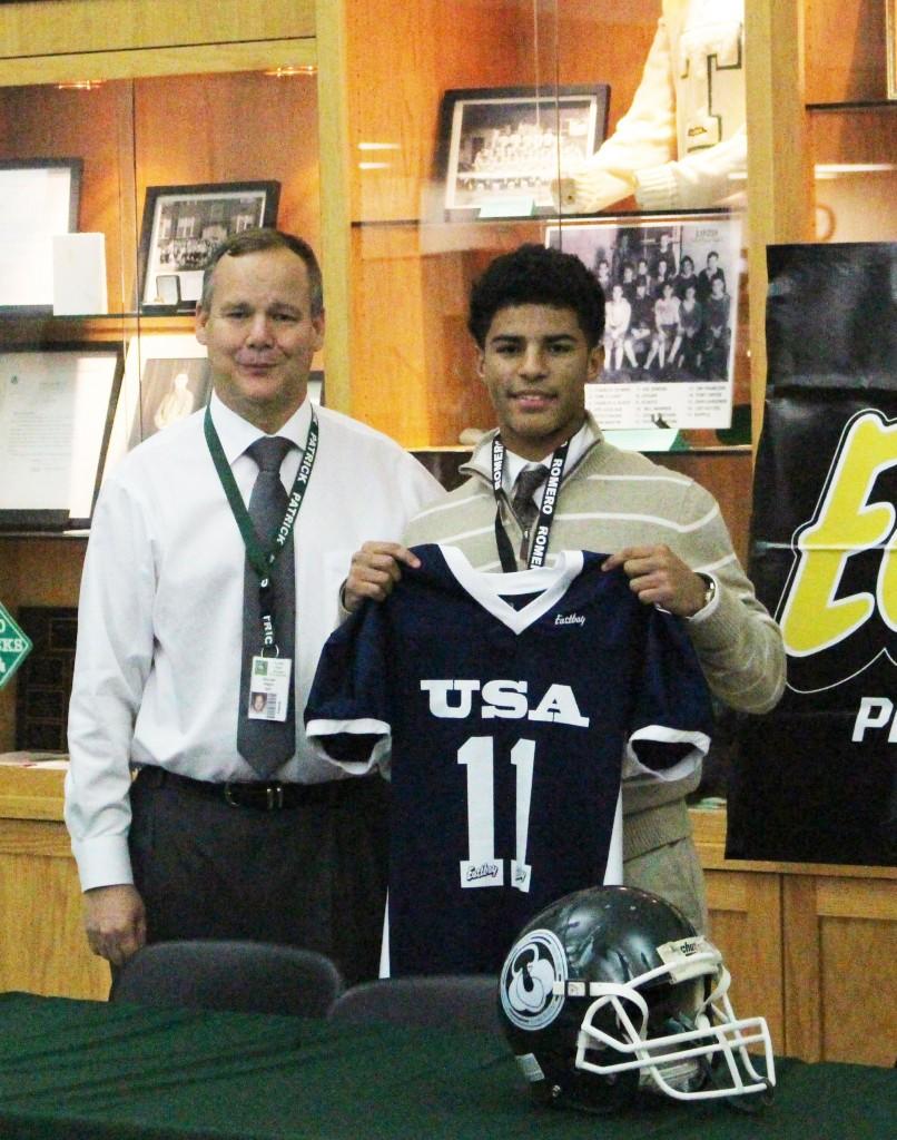 Trinity freshman football team quarterback Larry Harper was honored in a ceremony after school Dec. 11 in Alumni Hall. Harper was honored by Football University as an All-American freshman player.  Trinity freshman football team head coach Mike Magre is at left.                                -- photo by Devon Little 