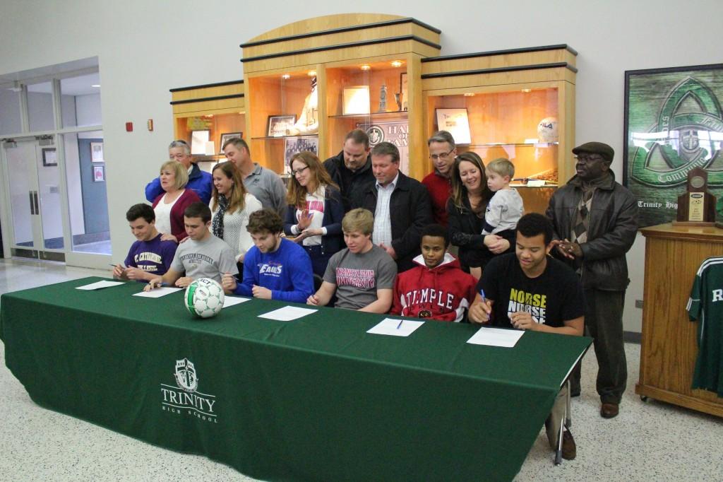 Trinity High School seniors Ian Logsdon (St. Catherine University), Ryan Payne (Northern Kentucky University),  Jacob Dickerson (Southern Indiana University), Jacob Gantt (Transylvania University, Division III), Dinho Zwane (Temple University) and Kobie Qualah (Northern Kentucky University) signed national letters of intent to participate in collegiate athletics at a ceremony held Feb. 12 at Trinity.      photo by David Mulhall